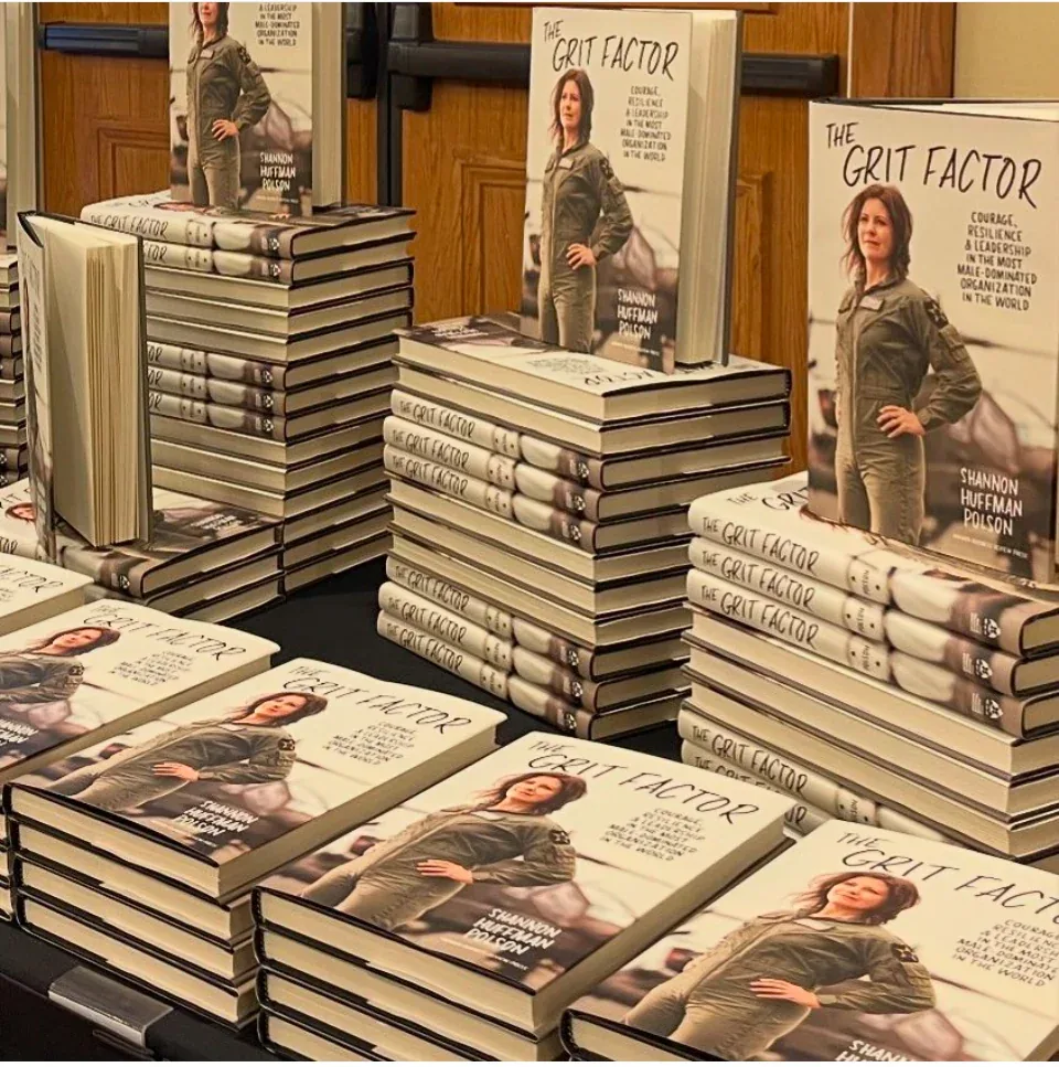 Shannon Huffman Polson at a book signing table with copies of The Grit Factor